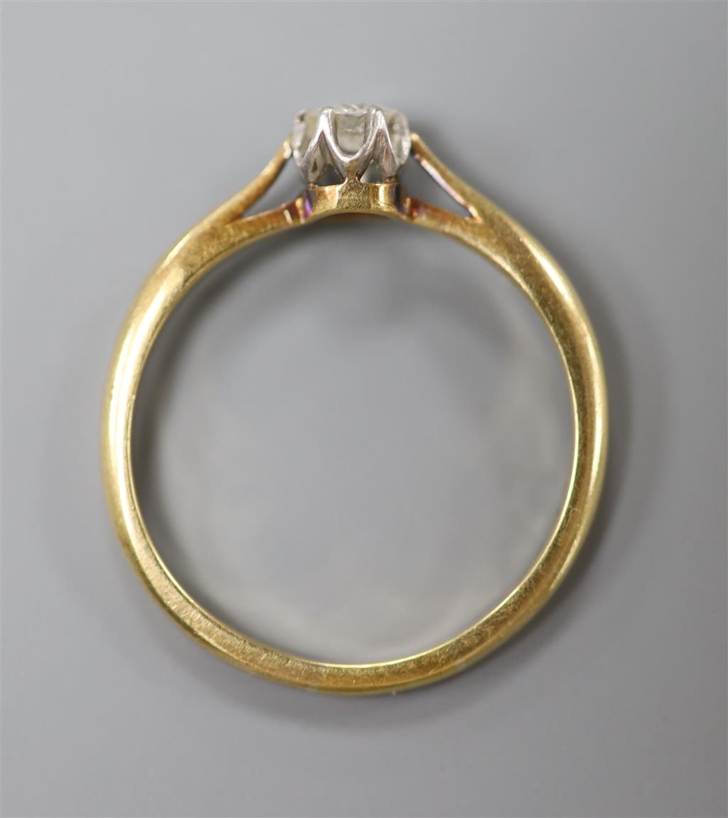 An 18ct and solitaire diamond ring, size Q, gross 2.5 grams, the stone weighing approximately 0.10ct.